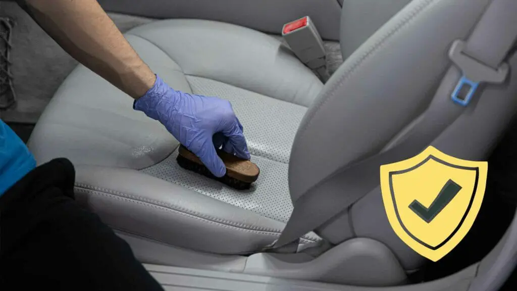 Photo of a person applying sealer to a leather seat.